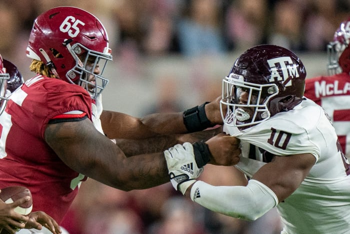 Texas A&M Aggies Defensive lineman Fadil Diggs takes on a block against Alabama offensive lineman JC Latham at Bryant-Denny Stadium.